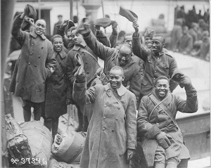 Grouping of Servicemen waving hats in air